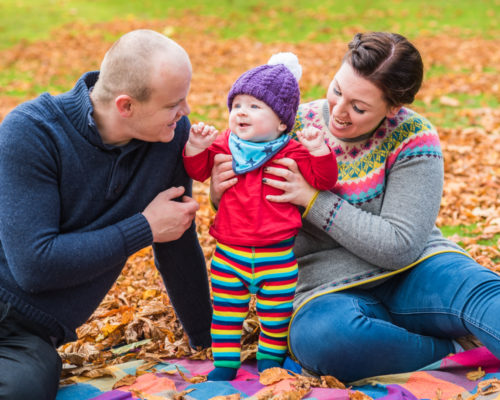 Family cuddles for photo session in Autumn
