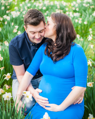 Kisses in the daffodils in Cumbria on a maternity portrait session