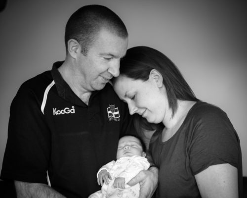Family cuddles for newborn photos in Cockermouth