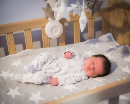 Newborn Abby sleeping in her crib in Cockermouth