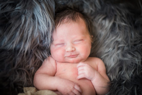 Baby smiles for newborn portraits in Carlisle