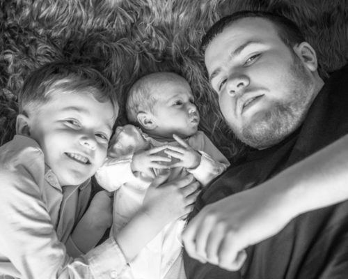 Siblings cuddle, newborn photographer Cumbria