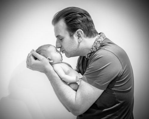 Dad kissing baby, newborn photographer Cumbria