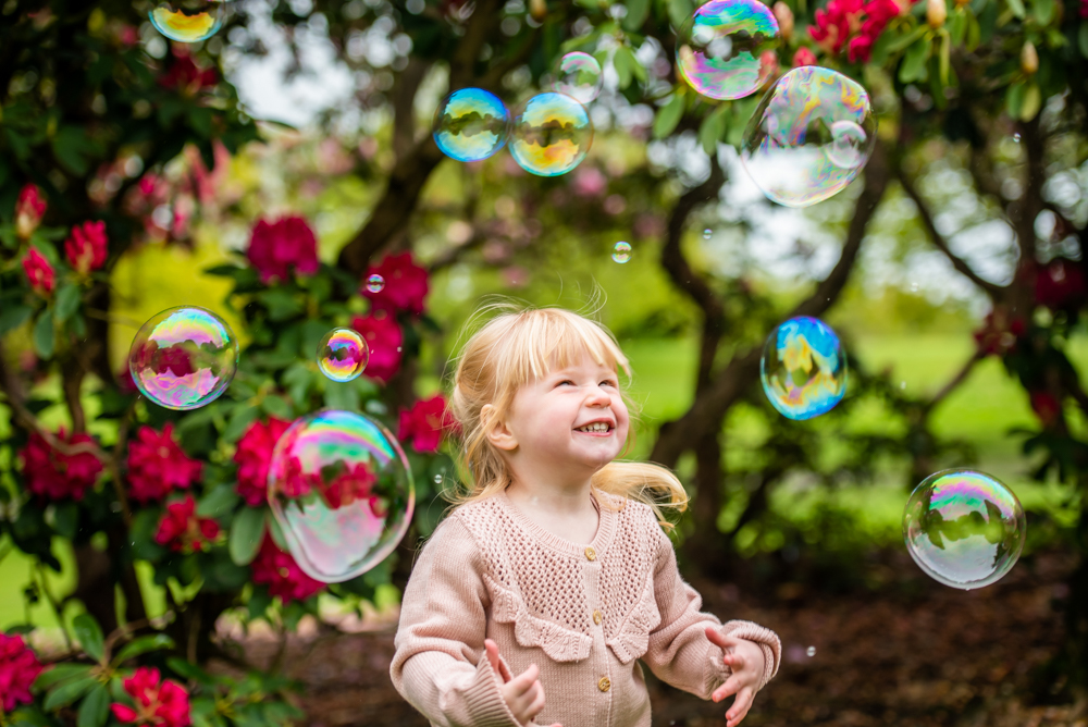 Martha smiling in bubbles, Graves Park, Sheffield family photographers