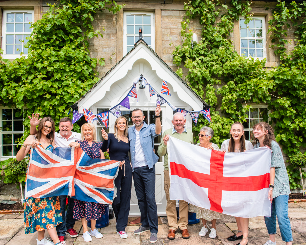 Family pose with flags, extended family portraits, Carlisle, Cumbria