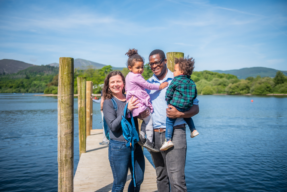 Family cuddle on jetty, Derwentwater portraits, Lake District