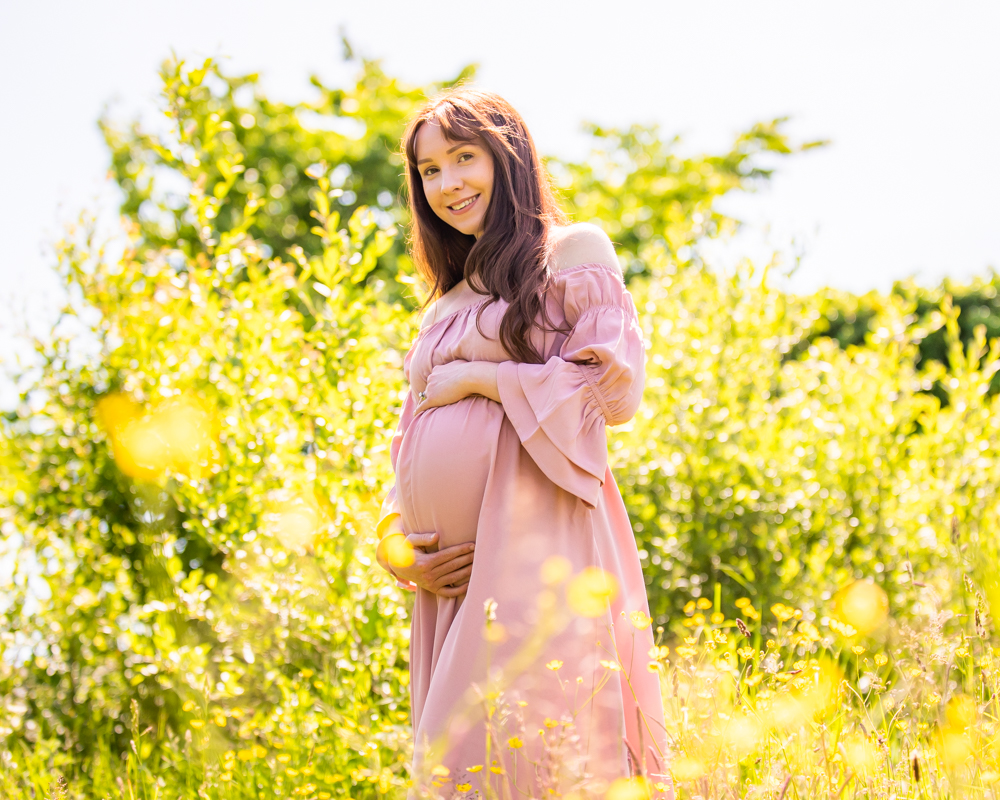 Baby bump posing in yellow flower field, Fletchertown, Lake District Maternity portraits