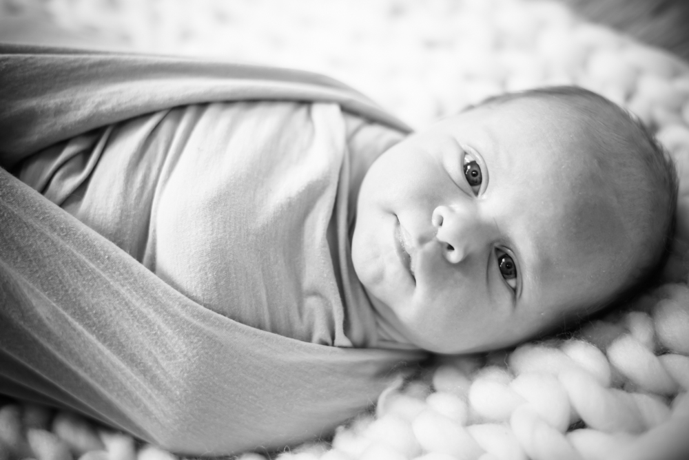 Newborn baby wrapped looking at camera, baby photographers Cockermouth