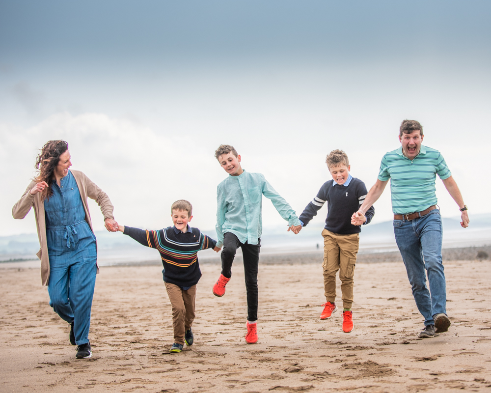 Family run along beach, Allonby family portraits, Cumbria