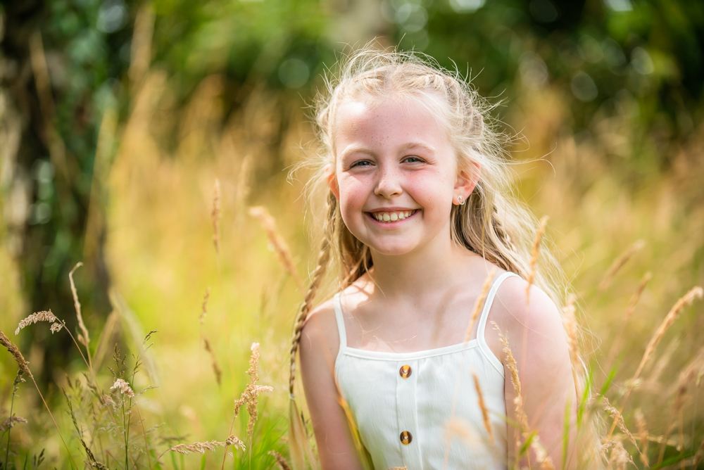 Honey smiling in long grasses, Fletchertown portraits, Lake District