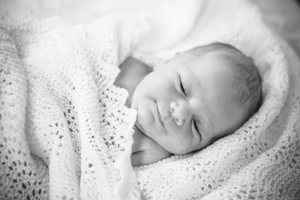 Baby smiling in blanket, newborn photographers Cockermouth